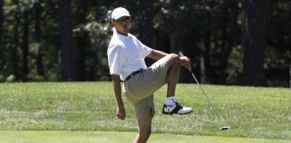 President Barack Obama reacts as he misses a shot while golfing on the first hole at Farm Neck Golf Club in Oak Bluffs, Mass., on the island of Martha's Vineyard on Sunday, Aug. 11, 2013. (AP Photo/Jacquelyn Martin)