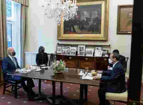 Double-masked Biden gives Japan's Prime Minister a burger and fries