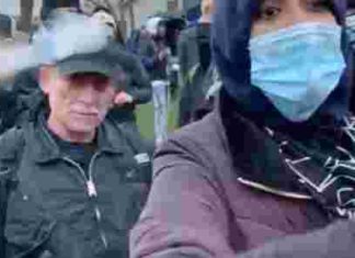Protesters chase CNN away from the police station, hit one with a bottle