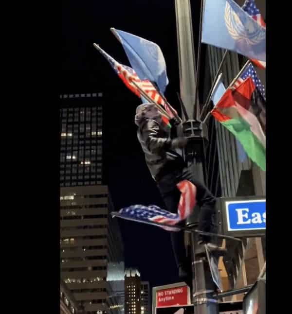 NextImg:Masked Men Tear Down US Flags, Threaten Cops While Waving Palestine Flag